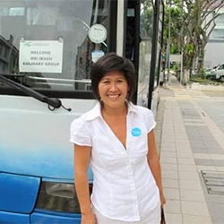 Mei in front of tour bus